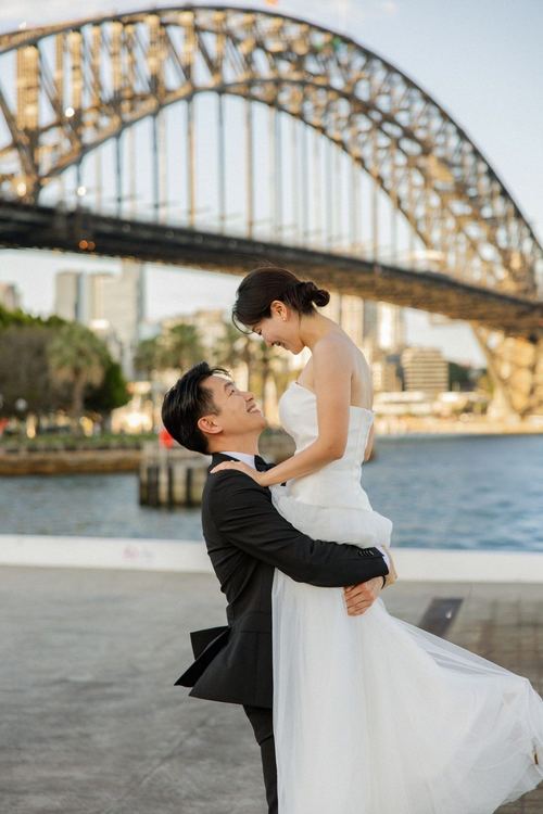 Frank lifting Seoyun beside the harbour