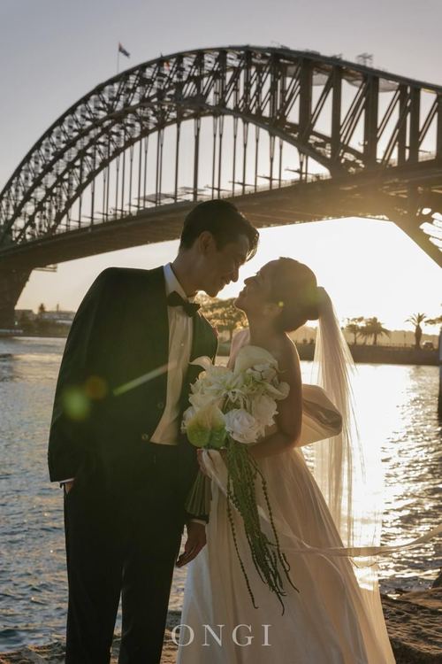 Frank and Seoyun at sunset beneath the Harbour Bridge, in black and white